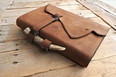 a brown leather journal with two horns on it