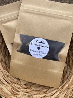 two bags of tea sitting on top of a basket