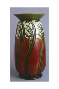 a red and white vase sitting on top of a table