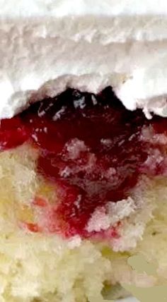 a piece of cake with white frosting and strawberry topping