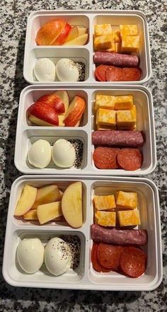 four plastic containers filled with different types of food