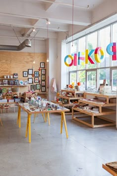 an open room with tables and pictures on the wall