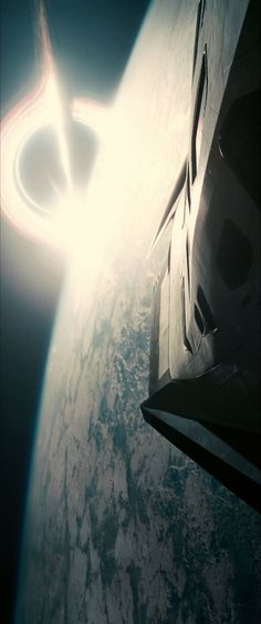 the sun is shining through the window of a space shuttle as it flies over earth