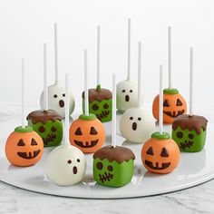 there are many halloween cake pops on the plate