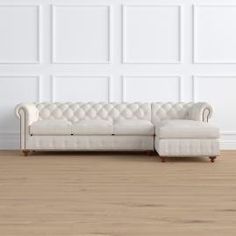 a white couch sitting on top of a hard wood floor