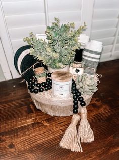 a potted plant sitting on top of a wooden table next to candles and other items