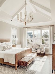 a bedroom with a large bed and white walls