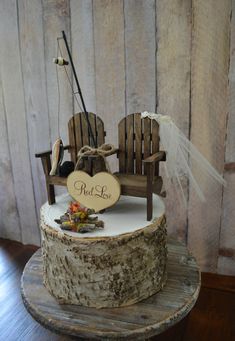 a wedding cake with a chair and fishing rod on top