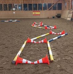 several orange and white traffic cones laying on the ground