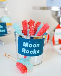 a cup filled with red, white and blue gummy bears sitting on top of a table