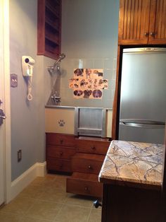 a kitchen with tile flooring and wooden cabinets