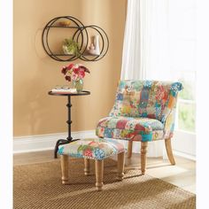 a colorful chair and foot stool in front of a window with flowers on the table