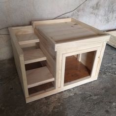 an unfinished wooden table with shelves on the bottom and one shelf in the middle for storage