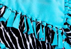 a blue and black zebra print dress with tassels