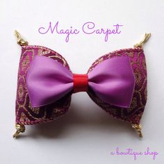 a close up of a bow tie on a white surface with the words magic carpet written above it