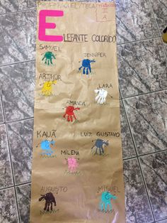 a brown paper bag with handprints on it and the letter e in different colors