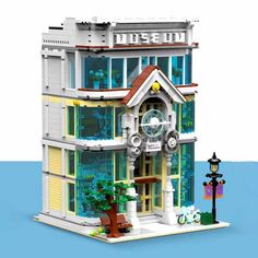 a lego model of a multi - story building with a clock on the top floor