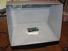 a toy train sitting inside of a metal box