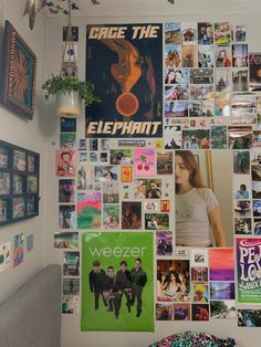 a bedroom wall covered in posters and pictures