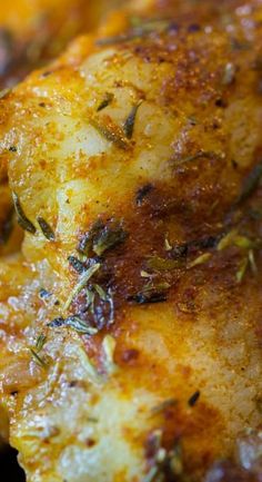 closeup of cooked chicken with herbs on it