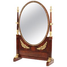 an ornate wooden stand with a mirror on it