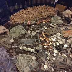 a pile of money sitting on top of a table next to stacks of pennets