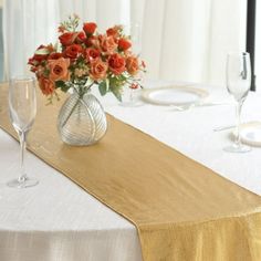 an elegant table setting with flowers and wine glasses