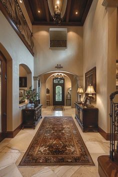 a large foyer with an ornate rug on the floor