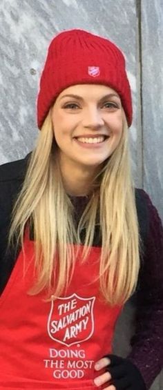 a woman wearing an apron and a red hat