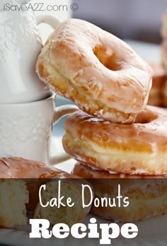 donuts stacked on top of each other in front of a cup and saucer