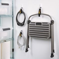 a wall mounted shower caddy next to several rolls of toilet paper and other bathroom accessories