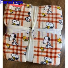 three cloths with snoopy dogs on them are folded up in the shape of squares