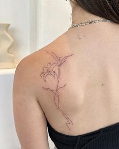 a woman with a flower tattoo on her back