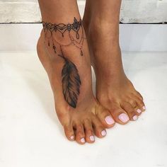 a woman's foot with a feather and beads tattoo on her left side leg