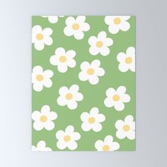 a green and white flowered pattern with yellow centers on the petals canvas wall art print