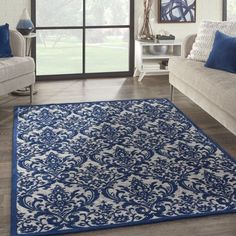 a blue and white rug in a living room