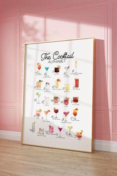 the cocktail alphabet poster in front of a pink wall