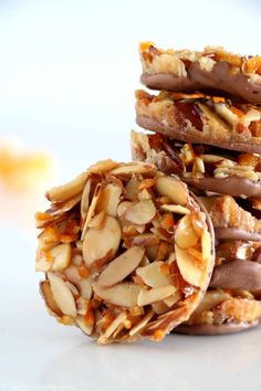 three pieces of food stacked on top of each other with chocolate drizzle and almonds