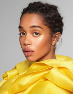 a close up of a person wearing a yellow dress