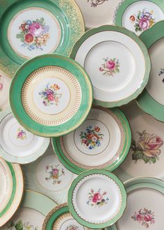 a pile of green and white plates sitting next to each other