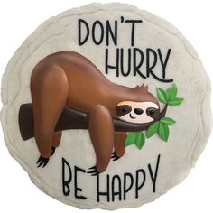 a ceramic sign with a slotty hanging from it's side that says, don't hurry be happy