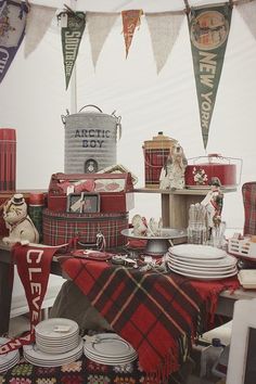 there are many items on the table that is set up for an outdoor party or celebration