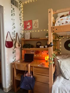 a bedroom with two bunk beds, a desk and a laptop on top of it