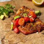 some meat and vegetables are on a cutting board