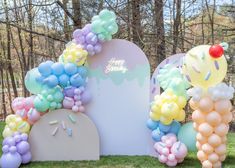 balloons are arranged in the shape of archs and arches for an outdoor birthday party