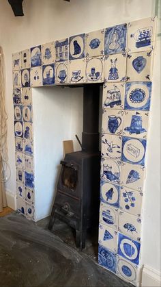 an old fashioned stove in a room with blue and white tiles