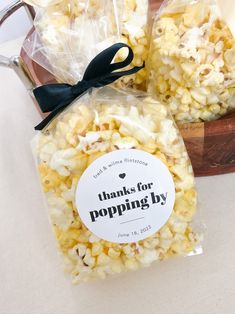 two bags of popcorn sitting on top of a table