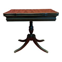 an old wooden table with a red cloth on it's top and two legs