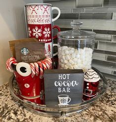 hot cocoa bar with candy, marshmallows and mugs