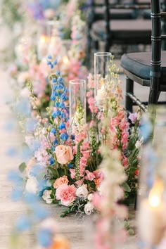 flowers and candles are lined up on the ground